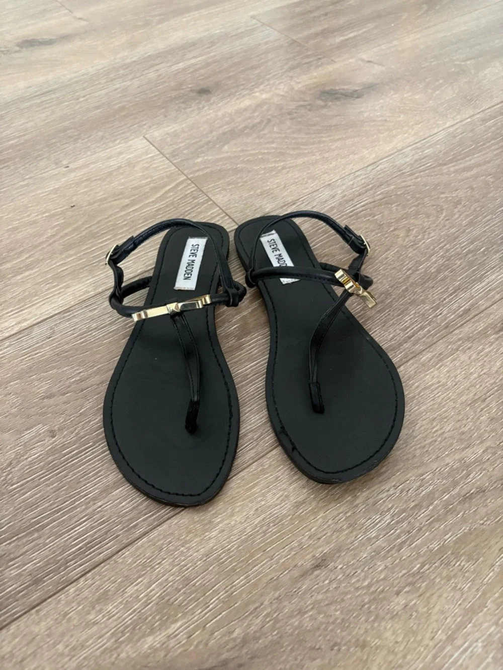 Steve Madden Black T-Strap Sandals with Gold Bow Accent